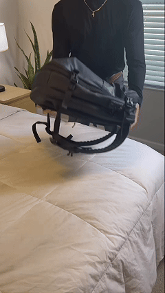 A customer handling the Max Travel Backpack